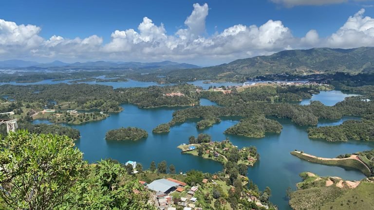 View from El Peñol – overlooking Guatape’s lake and lush hills from above Panoramic view of the Guatape reservoir and surrounding green islands seen from the top of El Peñol rock